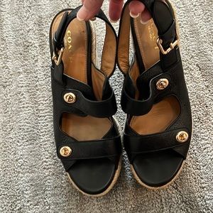 Coach 5” wedge sandal with gold embellishment.